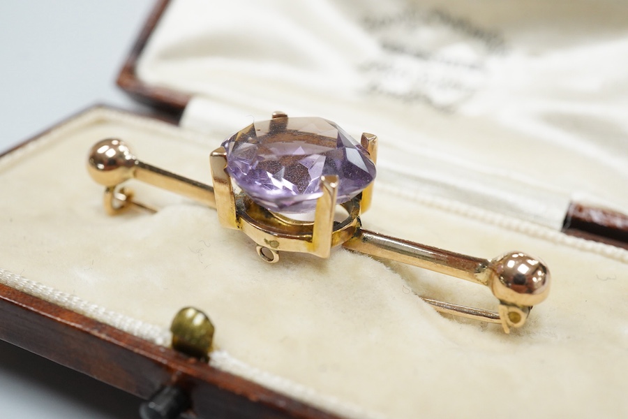 A cased late Victorian 9ct and single stone amethyst set bar brooch, 45mm, a cased yellow metal and single stone white opal set stick pin and a modern 18ct white gold, ruby and diamond cluster ring, size L/M.